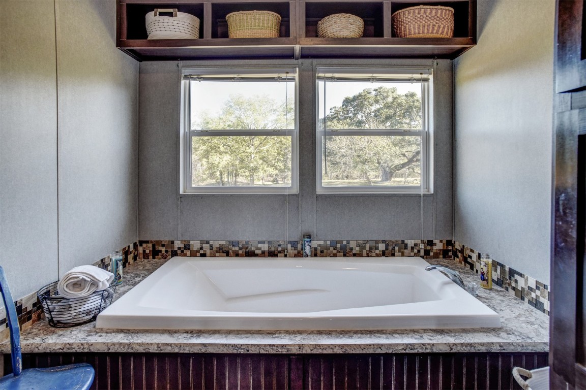 421 Krchnak Road Smithville, TX 78957 - Photo 20 of 40 a bathroom with a bathtub and window