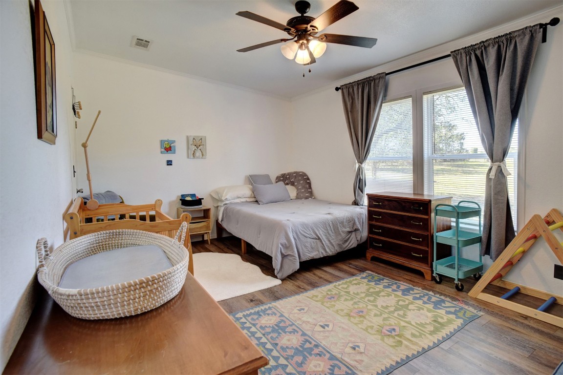 421 Krchnak Road Smithville, TX 78957 - Photo 21 of 40 a bedroom with furniture and a wooden floor