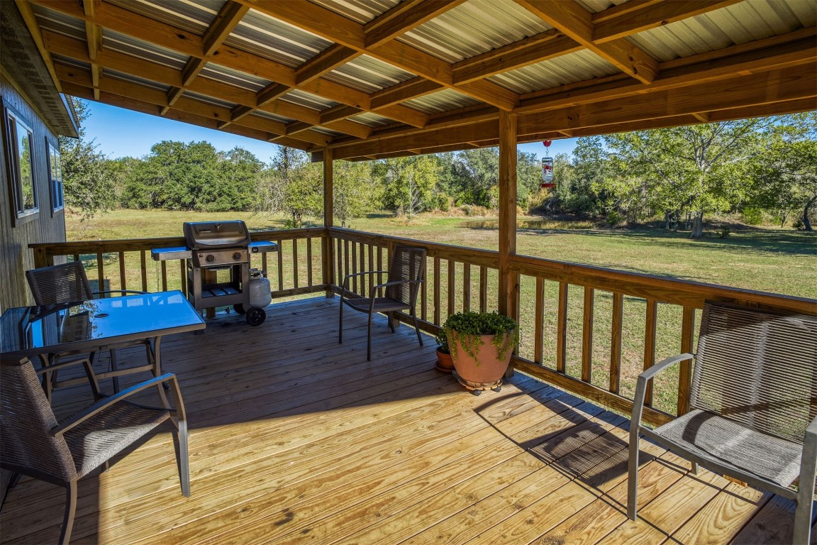421 Krchnak Road Smithville, TX 78957 - Photo 27 of 40 a view of a balcony with chairs and wooden floor