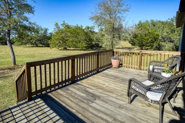 a view of an house with backyard and tree