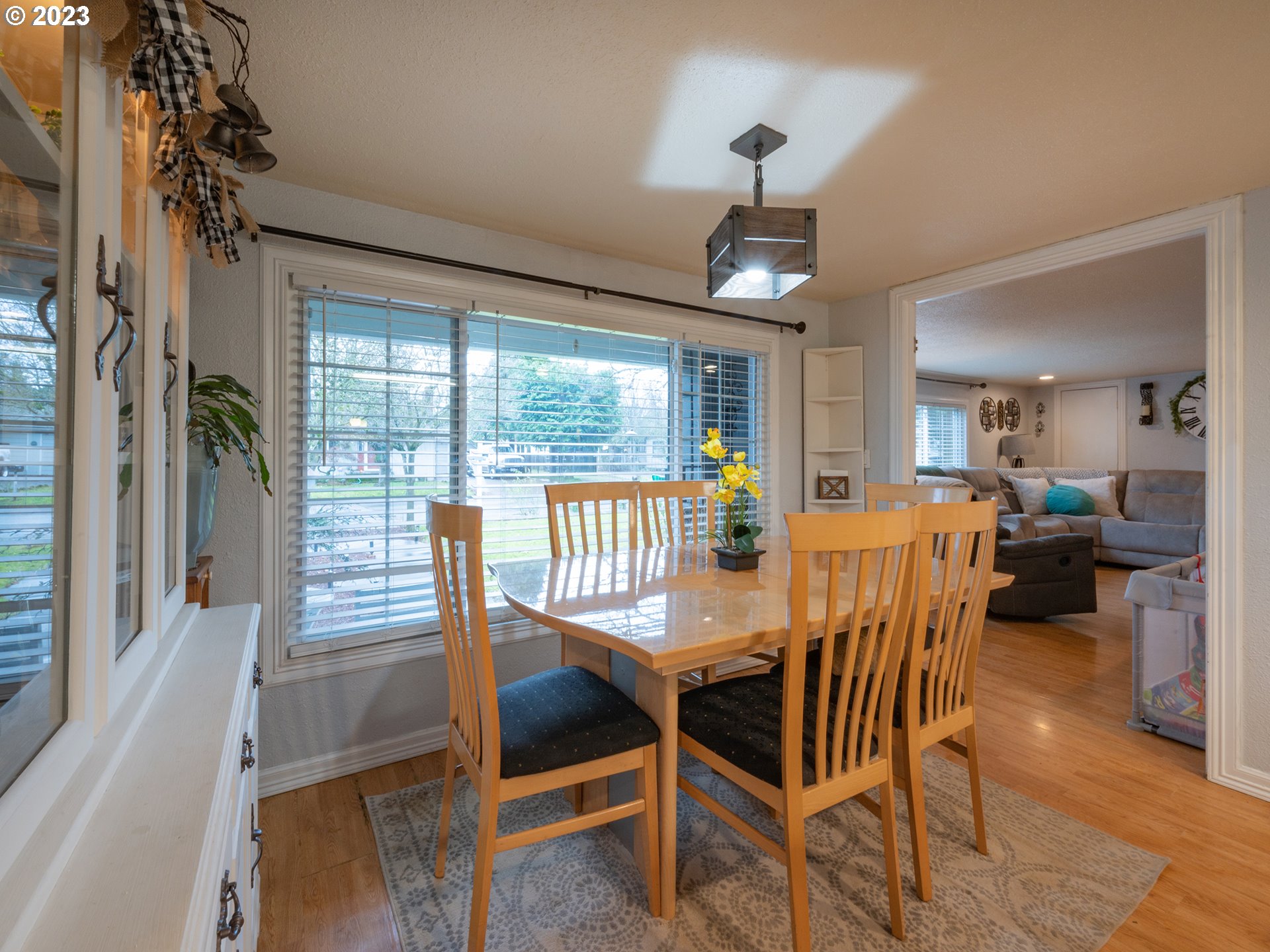 820 West Fairview Drive Springfield, OR 97477 - Photo 8 of 32 a dining room with furniture a chandelier and wooden floor
