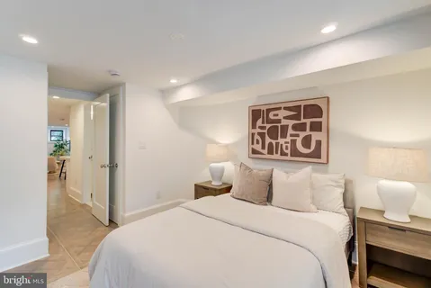 a bedroom with a bed and a night stand