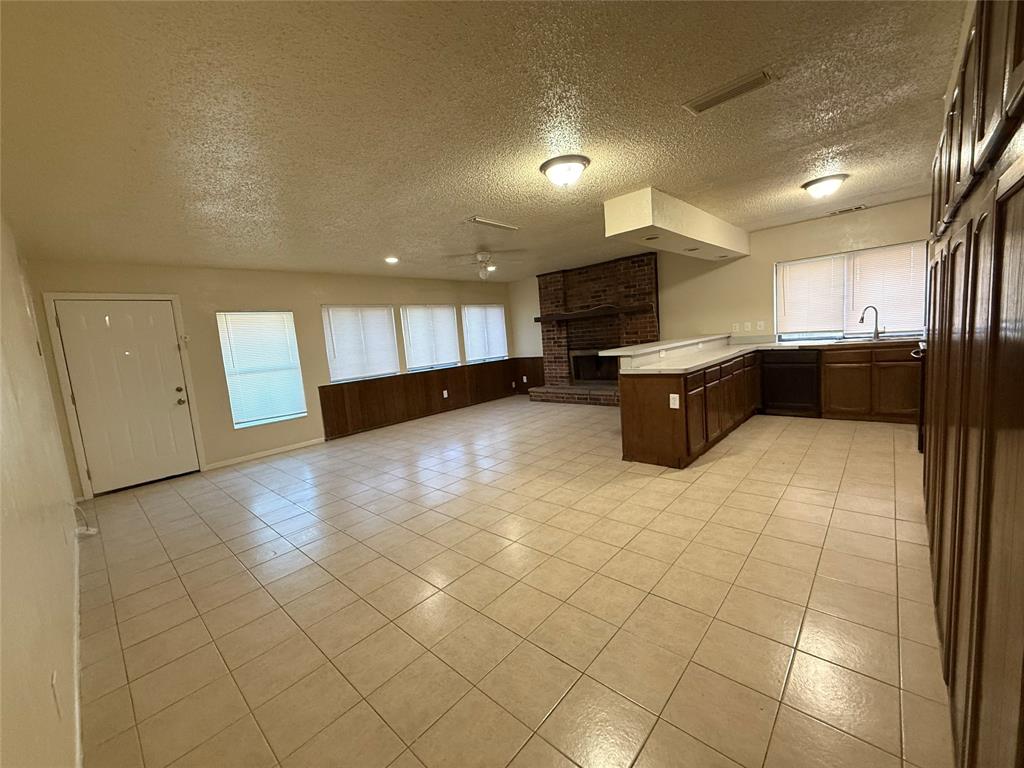 a view of a kitchen with a sink and a refrigerator