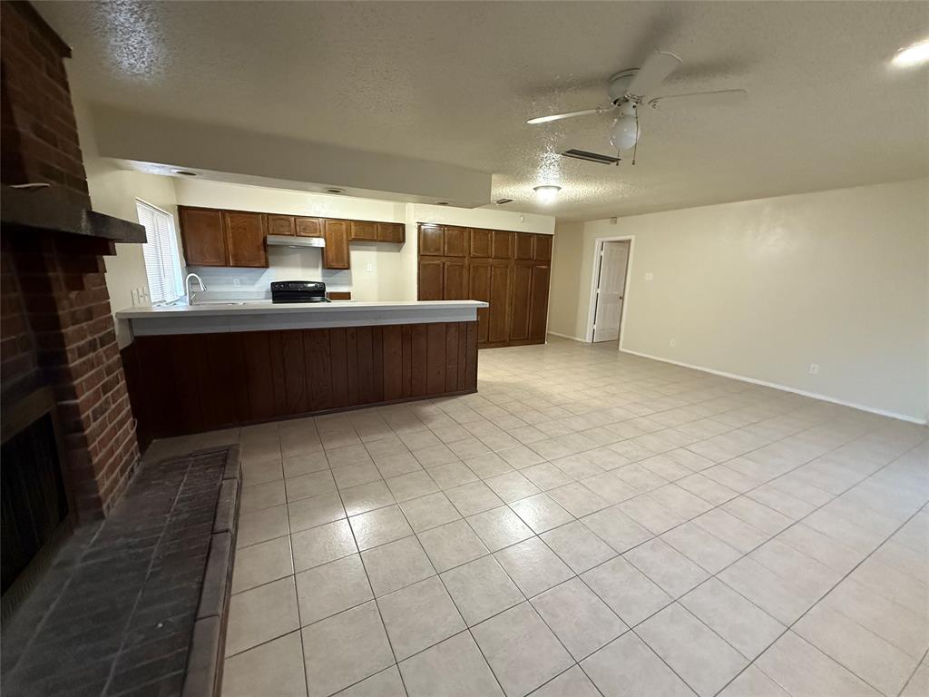 5005 Galaxie Road Garland, TX 75044 - Photo 6 of 8 a living room with a large window