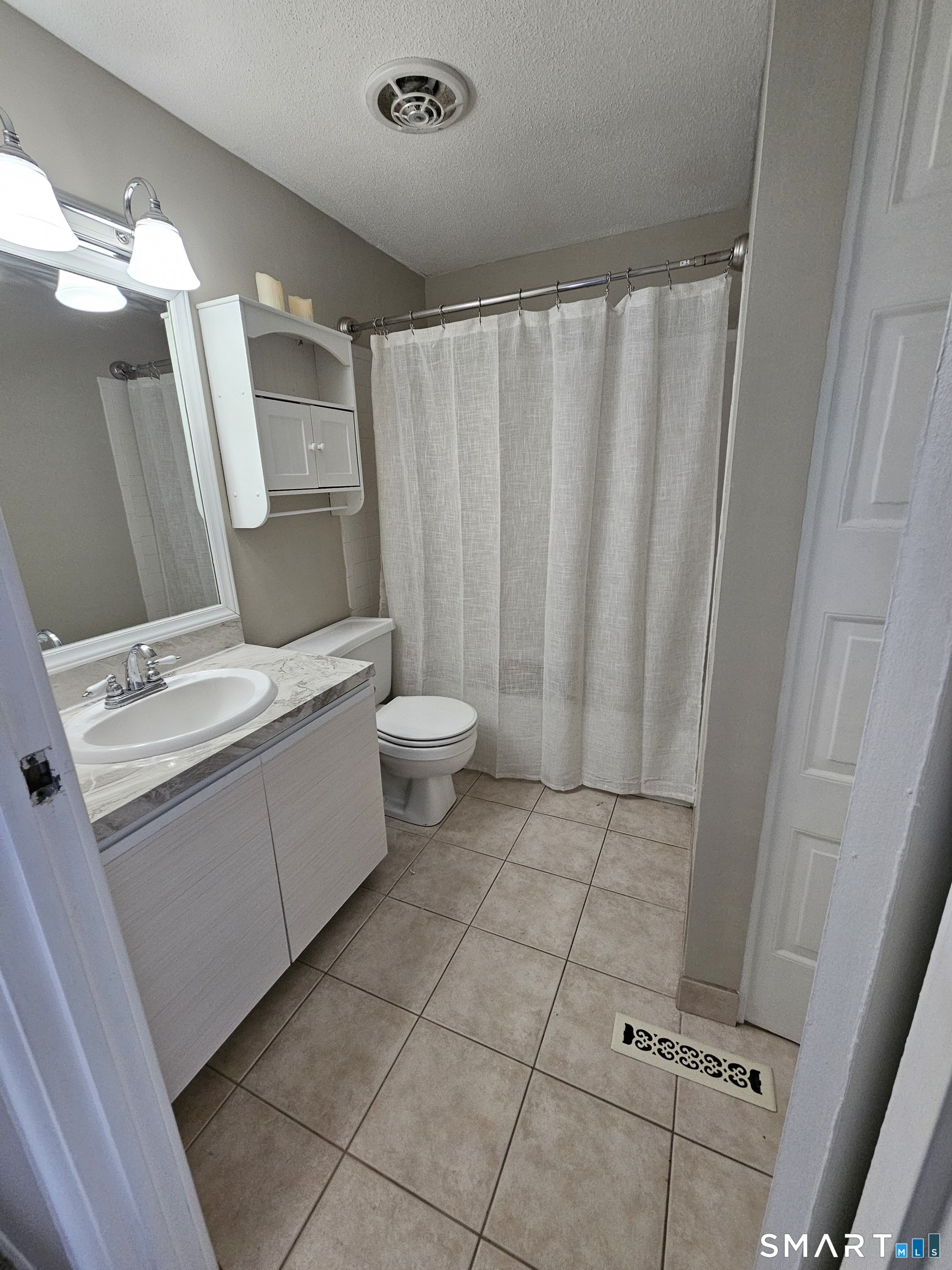 91 Trolley Crossing Lane, Unit 91 Middletown, CT 06457 - Photo 12 of 29 a bathroom with a sink a toilet and a mirror