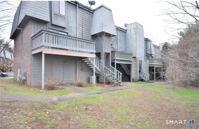 91 Trolley Crossing Lane, Unit 91 Middletown, CT 06457 - Photo 26 of 29 a view of a house with a yard and sitting area