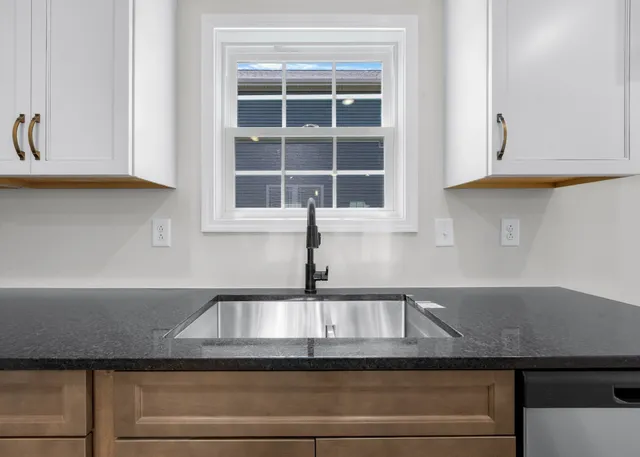 a kitchen with a sink and cabinets