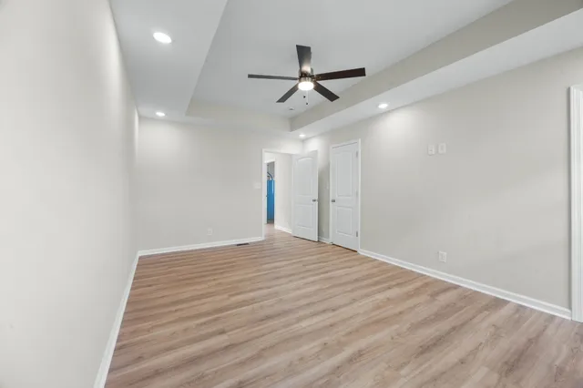 a view of empty room with wooden floor