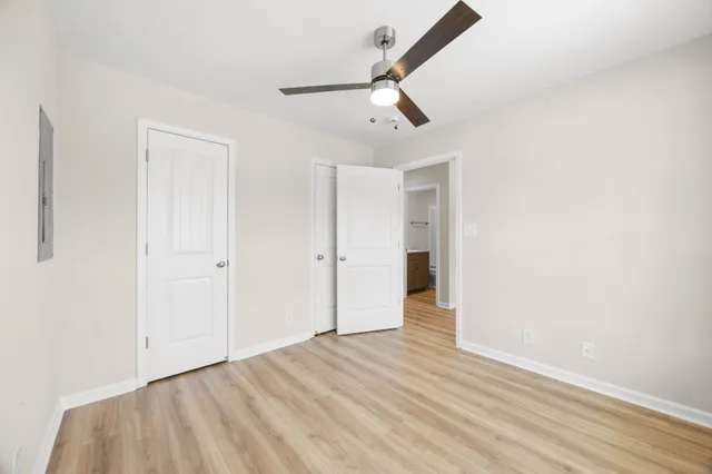 a view of an empty room with wooden floor