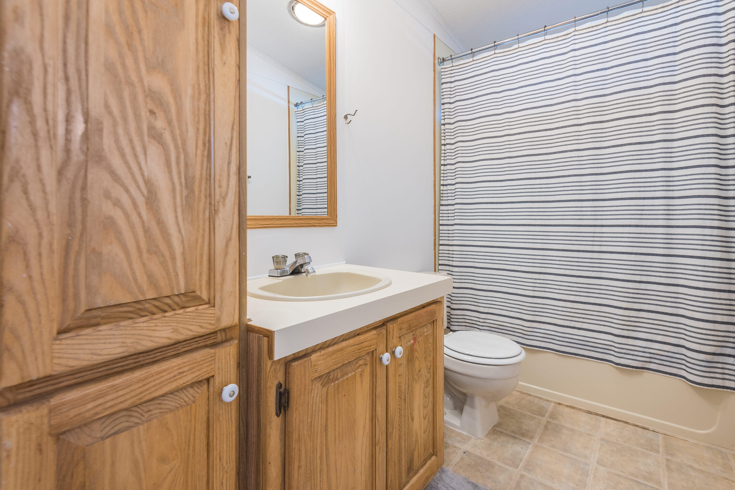 18749 Choctaw Road Bend, OR 97702 - Photo 13 of 22 a bathroom with a granite countertop sink toilet and shower