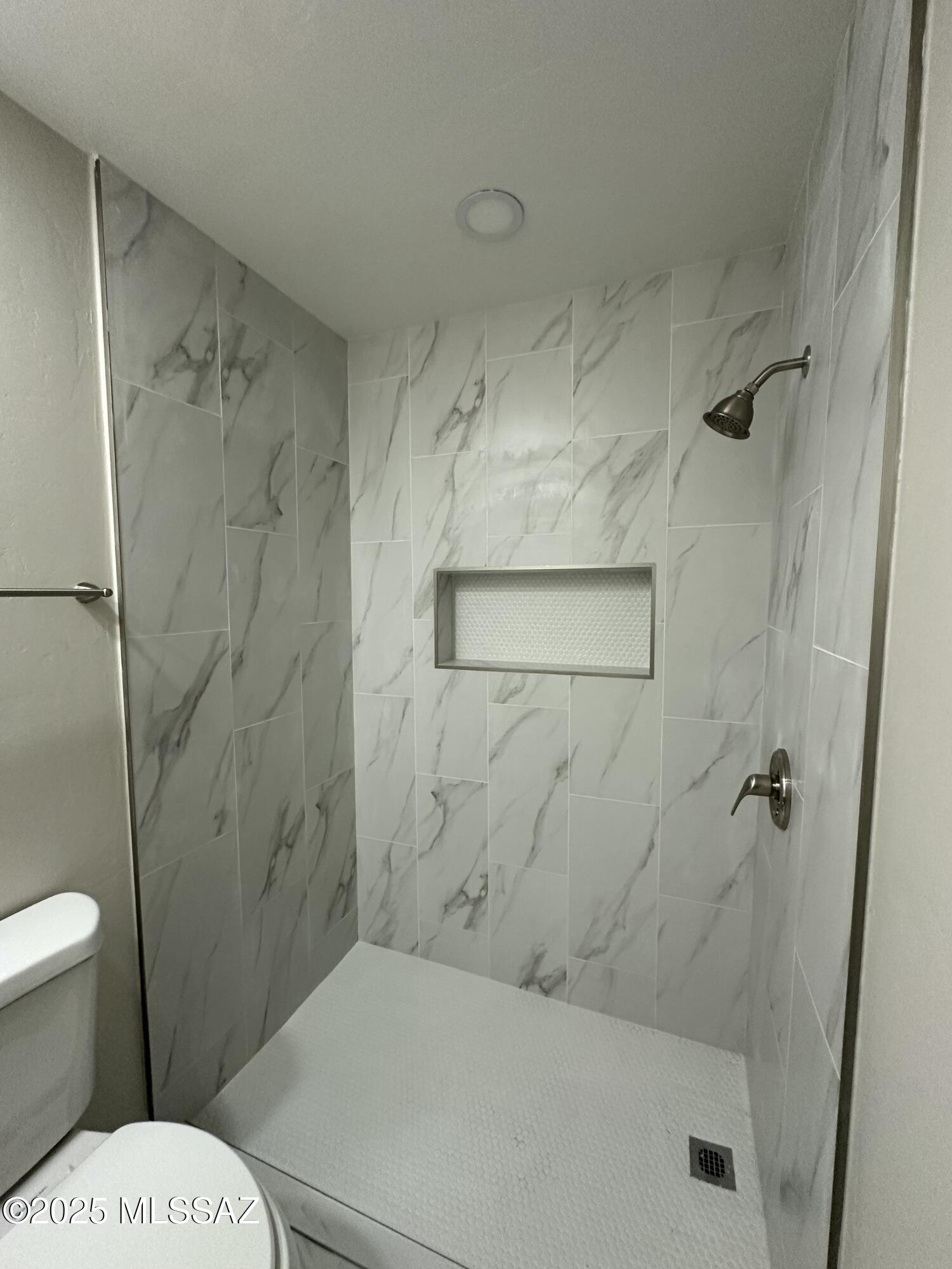645 East Mabel Street Tucson, AZ 85705 - Photo 12 of 22 a bathroom with a toilet and a shower