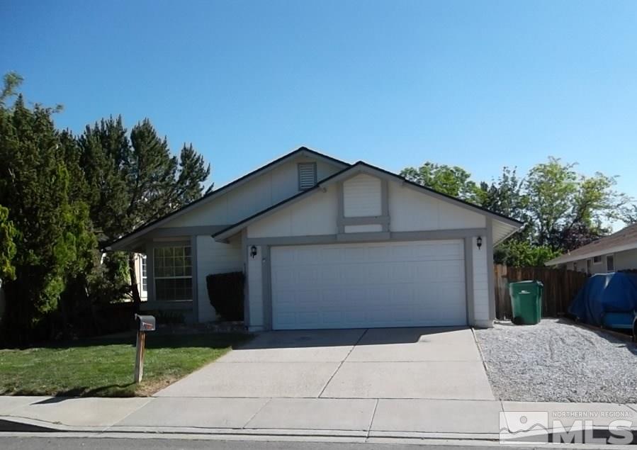 6129 Walnut Creek Road Reno, NV 89523 - Photo 1 of 15 a front view of house with garage and yard