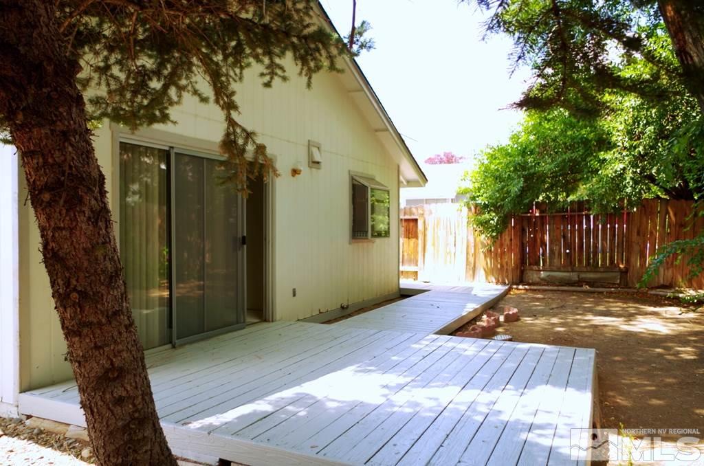 6129 Walnut Creek Road Reno, NV 89523 - Photo 11 of 15 a view of a house with a wooden fence and a large tree