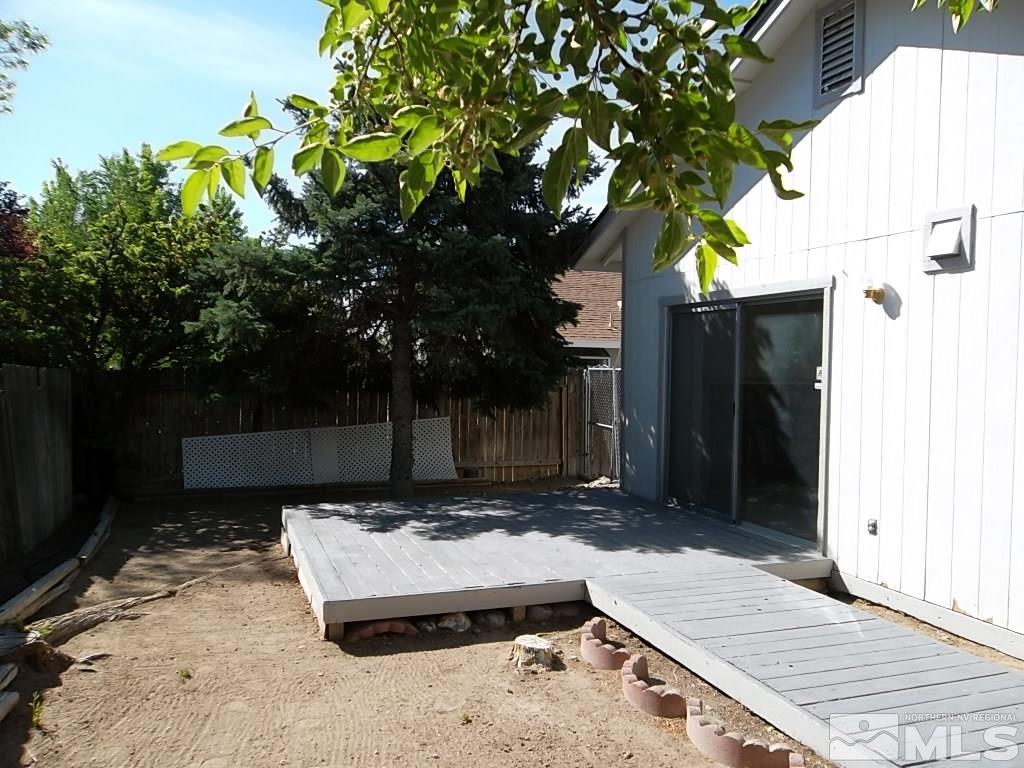 6129 Walnut Creek Road Reno, NV 89523 - Photo 14 of 15 a wooden bench sitting in front of a building