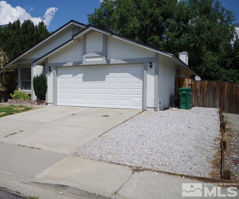 6129 Walnut Creek Road Reno, NV 89523 - Photo 2 of 15 a front view of a house with a yard and garage
