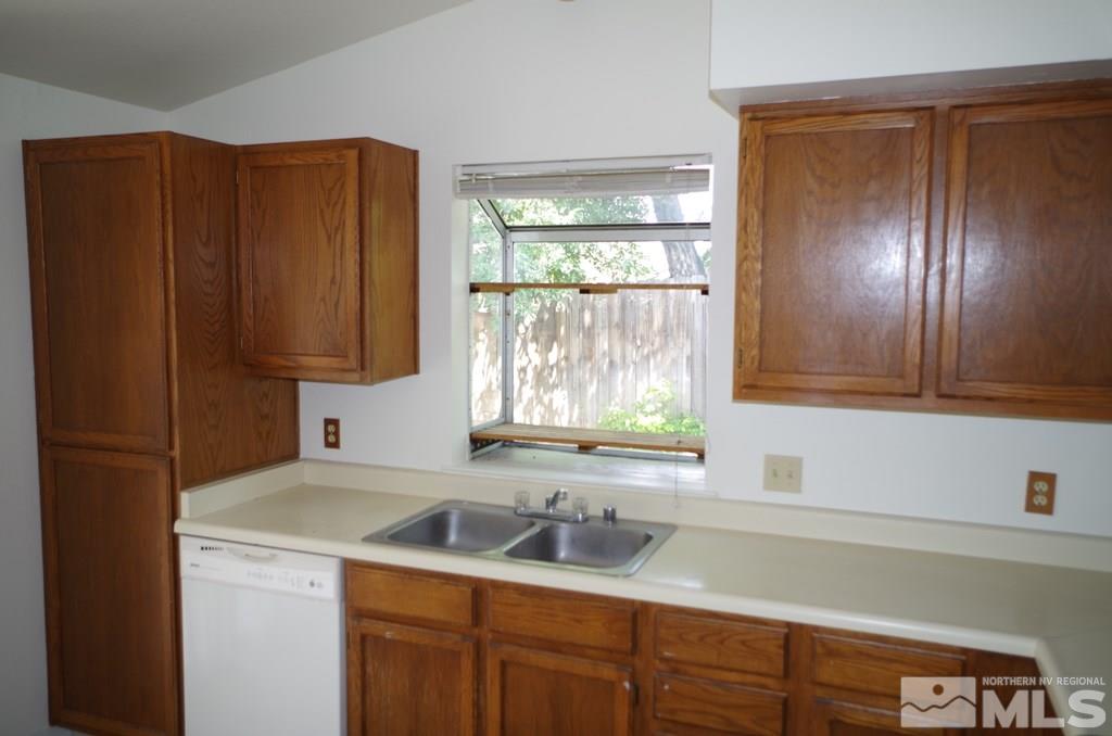 6129 Walnut Creek Road Reno, NV 89523 - Photo 4 of 15 a kitchen with wooden cabinets and a sink