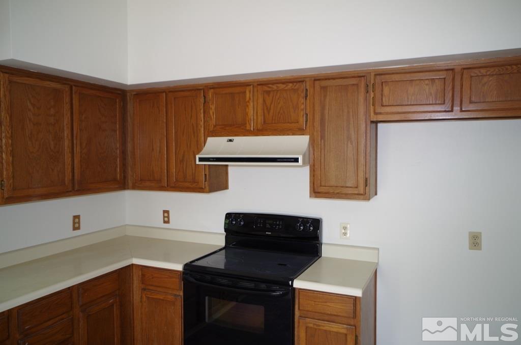 6129 Walnut Creek Road Reno, NV 89523 - Photo 5 of 15 a kitchen with a cabinets and appliances