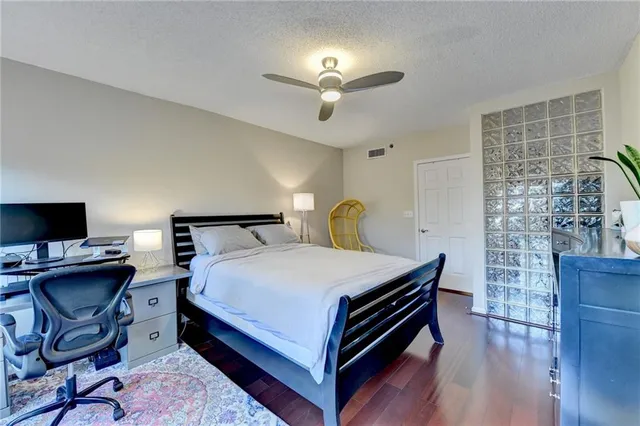 a bedroom with a bed and a desk