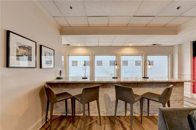 a dining hall with stainless steel appliances granite countertop a dining table and chairs