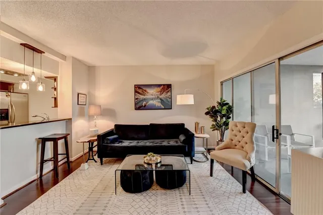 a living room with furniture windows and a potted plant