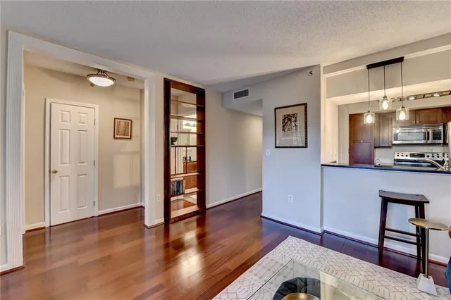 a view of a kitchen with furniture and wooden floor