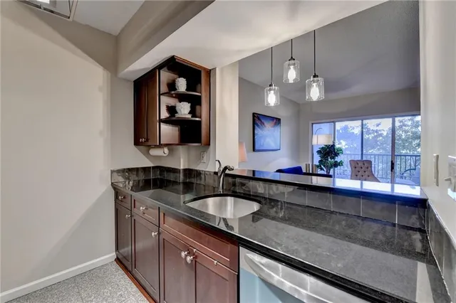 a kitchen with granite countertop a sink and cabinets