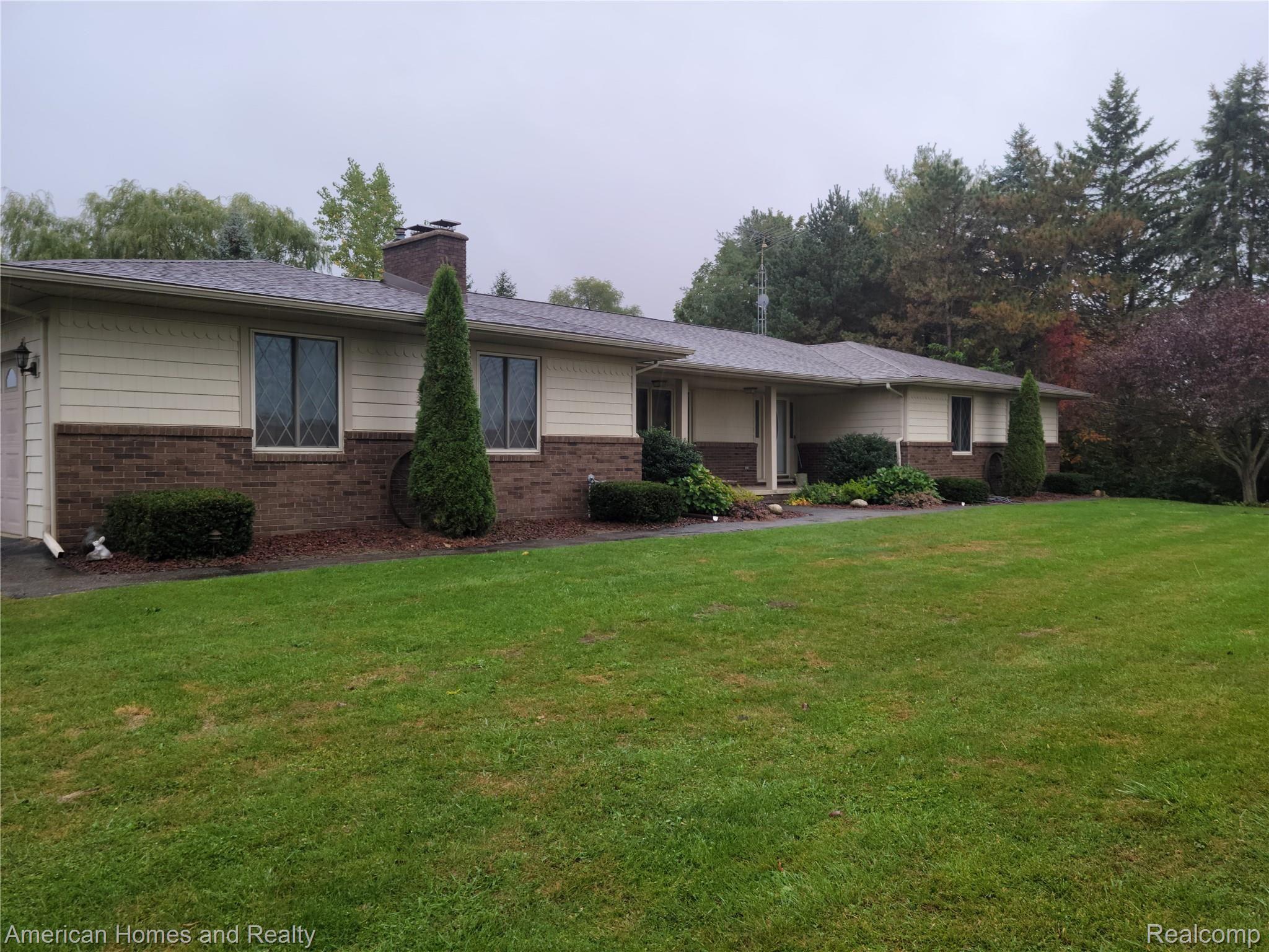 6530 Armstrong Road Imlay City, MI 48444 - Photo 51 of 59 Front of home with new roof in May 2020, brick and cedar shakes