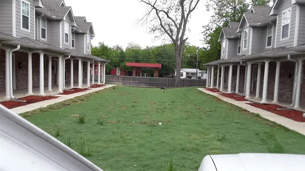 a view of a backyard with sitting area