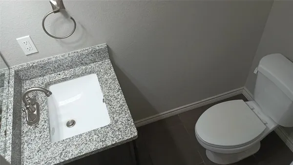 a bathroom with a toilet and a mirror