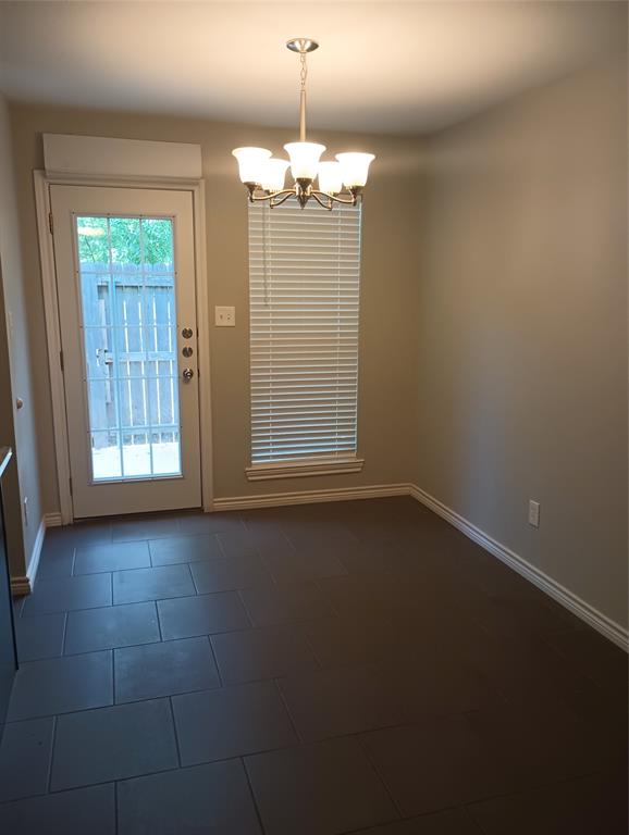 2004 Pecan Street, Unit G Commerce, TX 75428 - Photo 5 of 10 Doorway with a chandelier and tile patterned floors