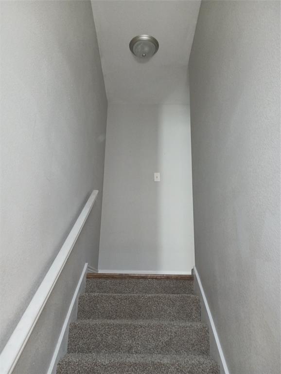 2004 Pecan Street, Unit G Commerce, TX 75428 - Photo 8 of 10 Stairway featuring carpet flooring