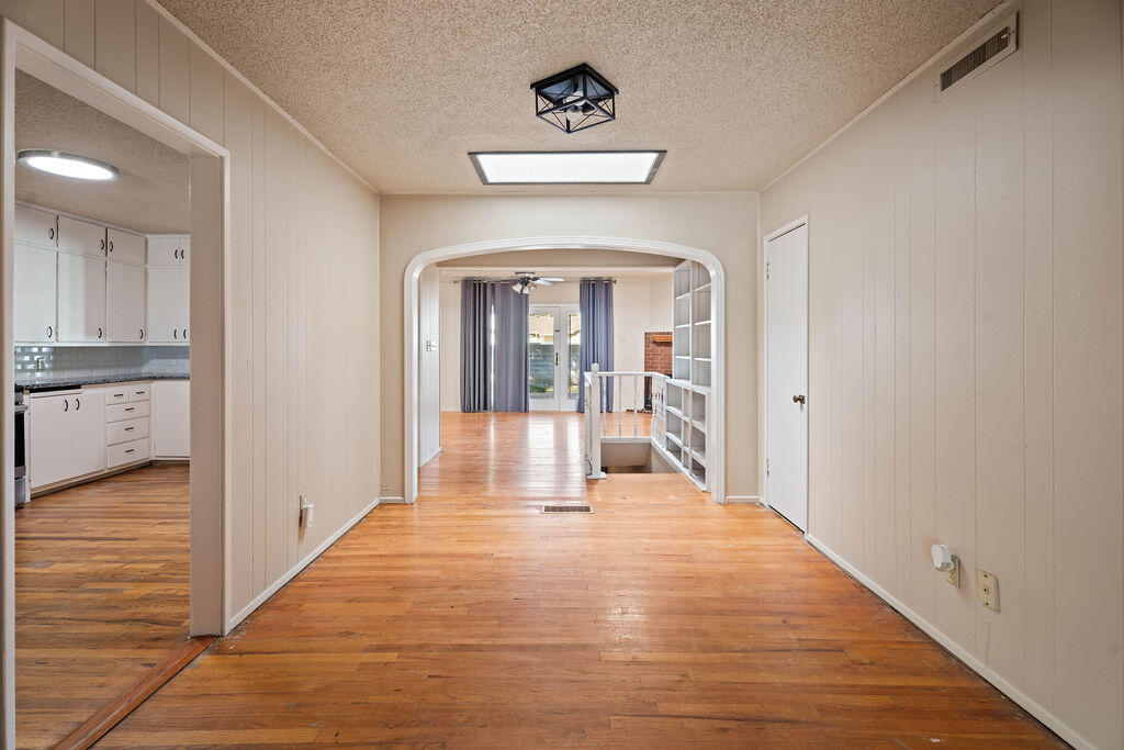 3514 25th Street Lubbock, TX 79410 - Photo 11 of 27 a view of a hallway view with wooden floor and a living room