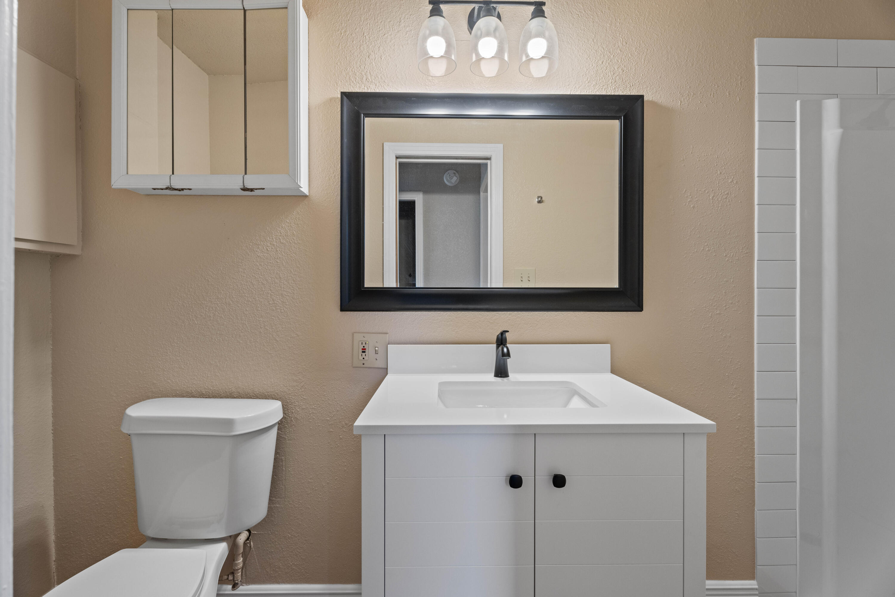 3514 25th Street Lubbock, TX 79410 - Photo 14 of 27 a bathroom with a toilet sink and mirror