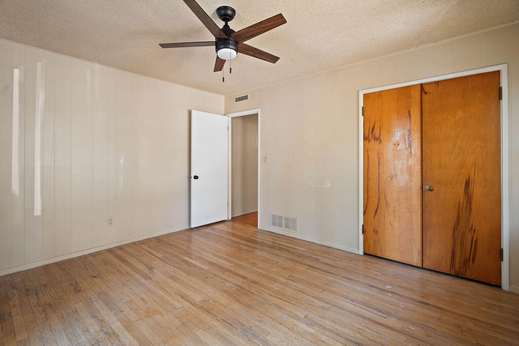 3514 25th Street Lubbock, TX 79410 - Photo 16 of 27 an empty room with wooden floor closet and ceiling fan