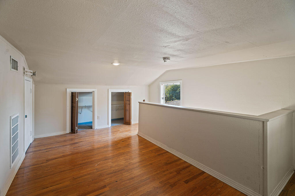 3514 25th Street Lubbock, TX 79410 - Photo 21 of 27 a view of an empty room with wooden floor and a window