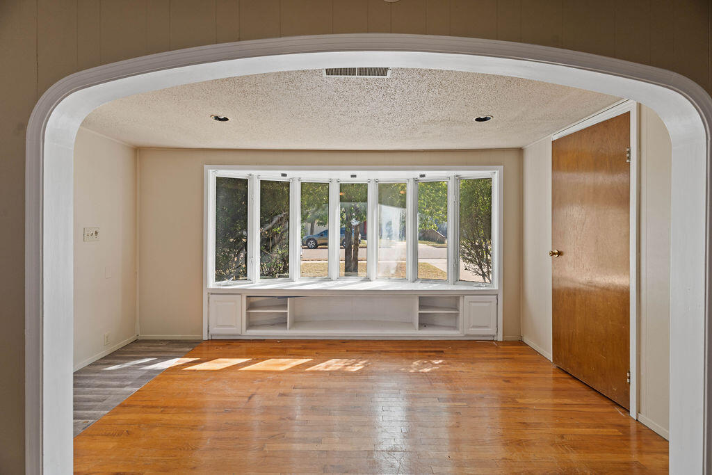 3514 25th Street Lubbock, TX 79410 - Photo 7 of 27 a view of empty room with wooden floor and fan