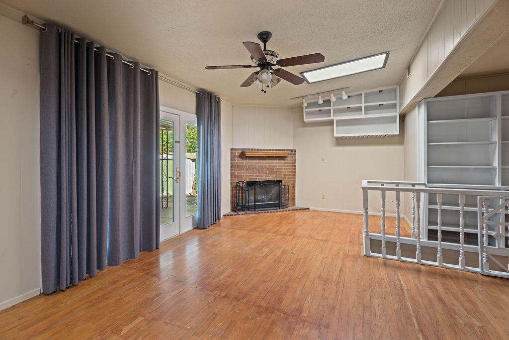 3514 25th Street Lubbock, TX 79410 - Photo 10 of 27 a view of an empty room with a fireplace and a window