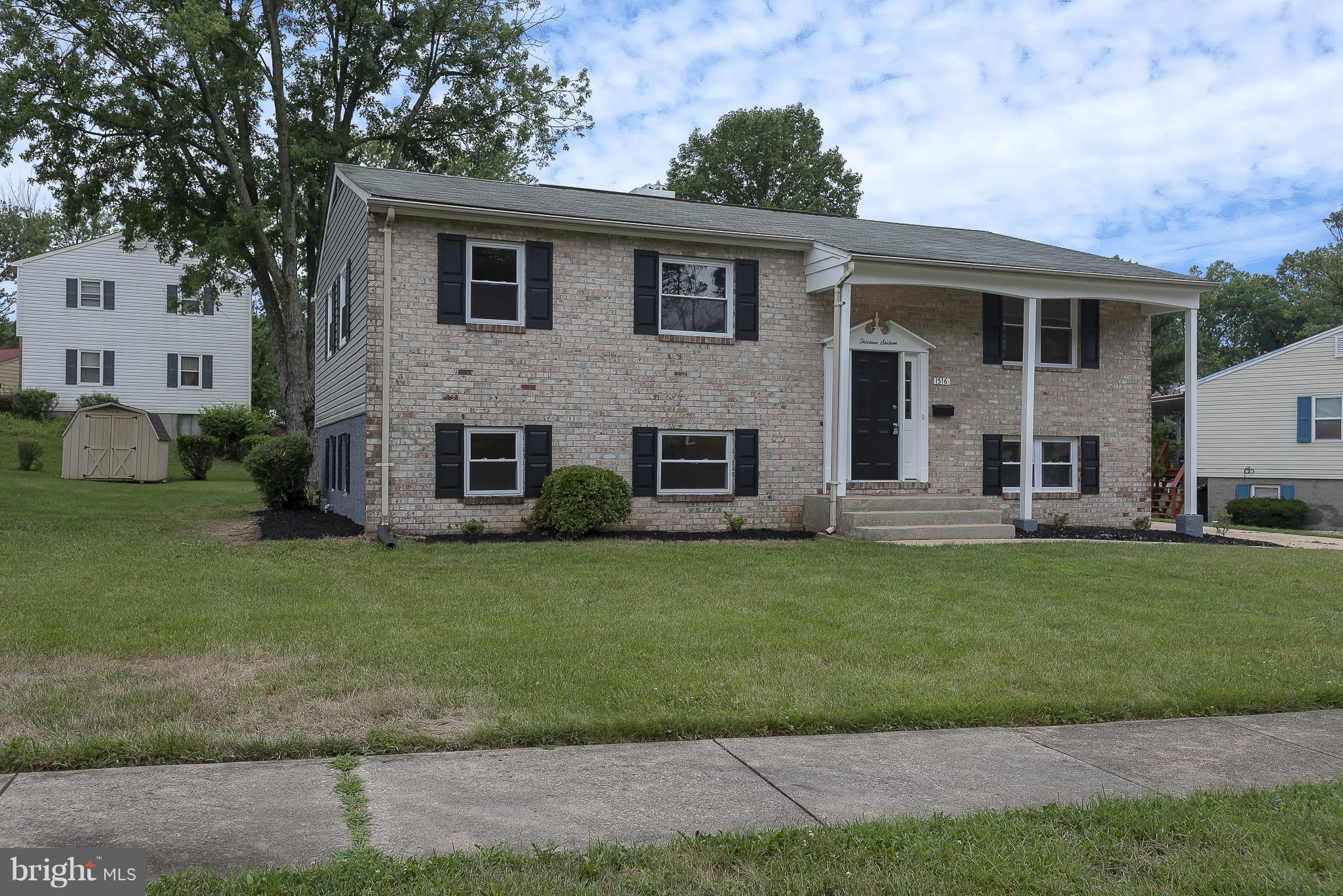 1316 Gatefield Road Baltimore, MD 21228 - Photo 1 of 30 a view of a yard in front of a house with a large tree