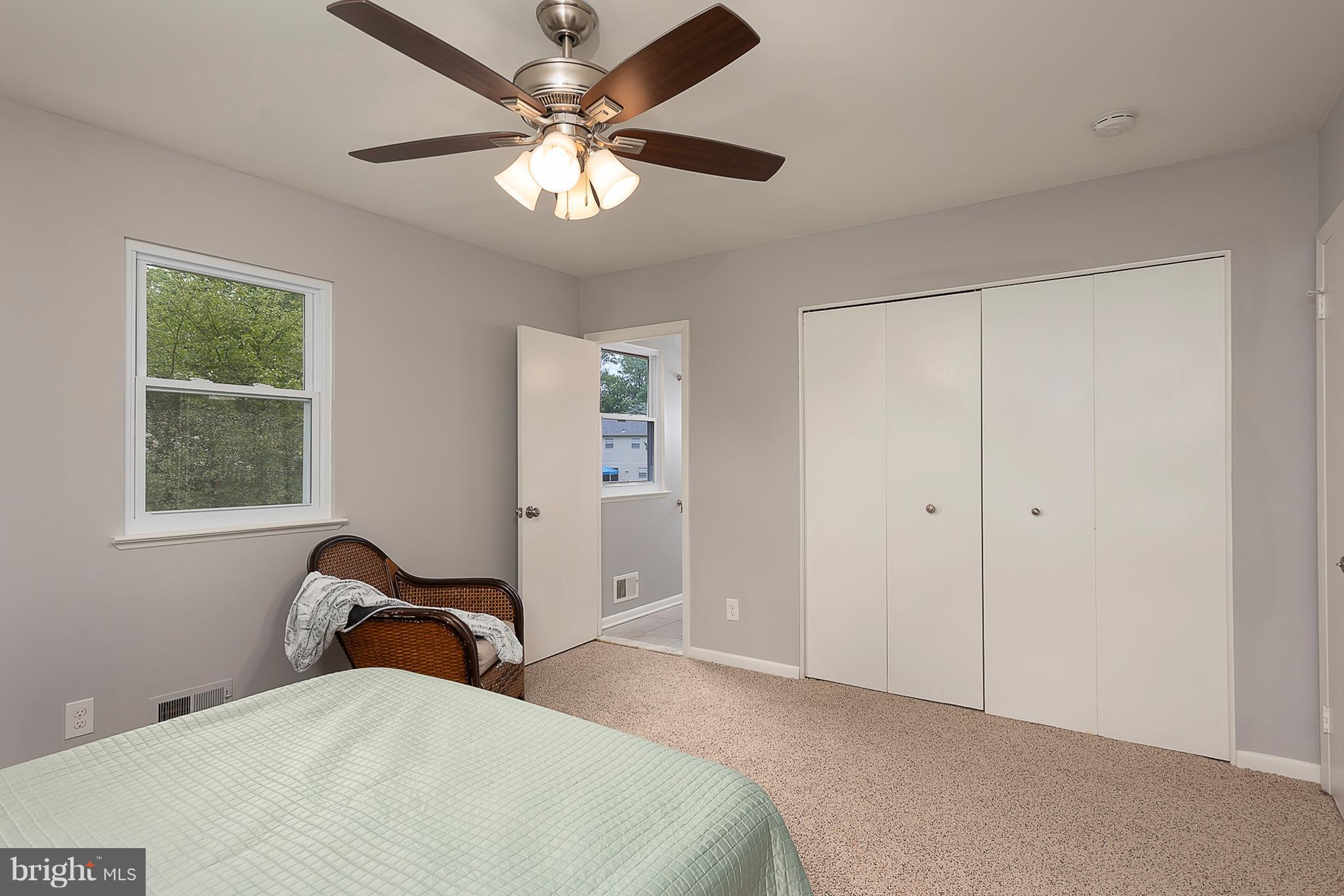 1316 Gatefield Road Baltimore, MD 21228 - Photo 14 of 30 a bedroom with a bed and a chandelier