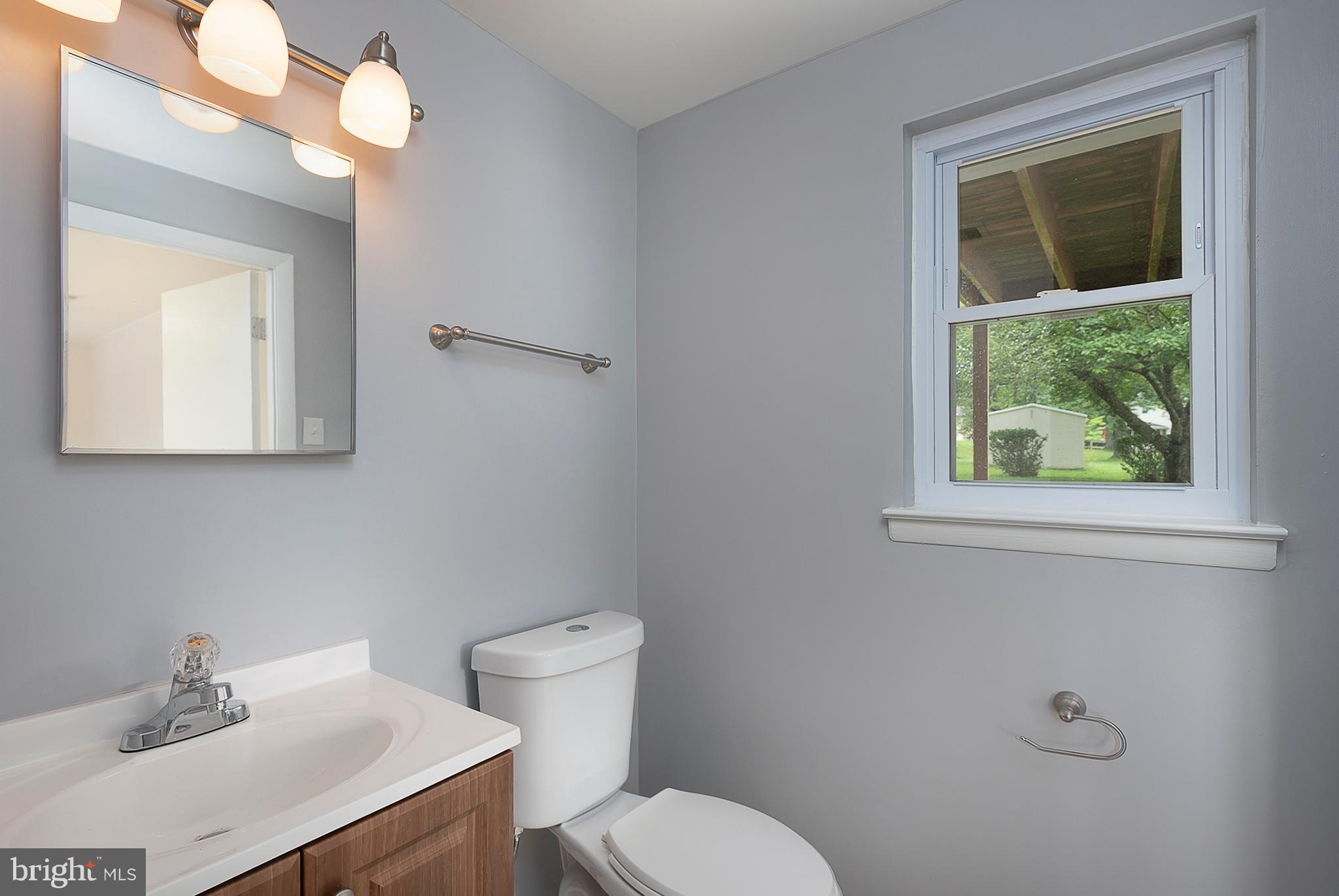 1316 Gatefield Road Baltimore, MD 21228 - Photo 22 of 30 a bathroom with a sink mirror and toilet