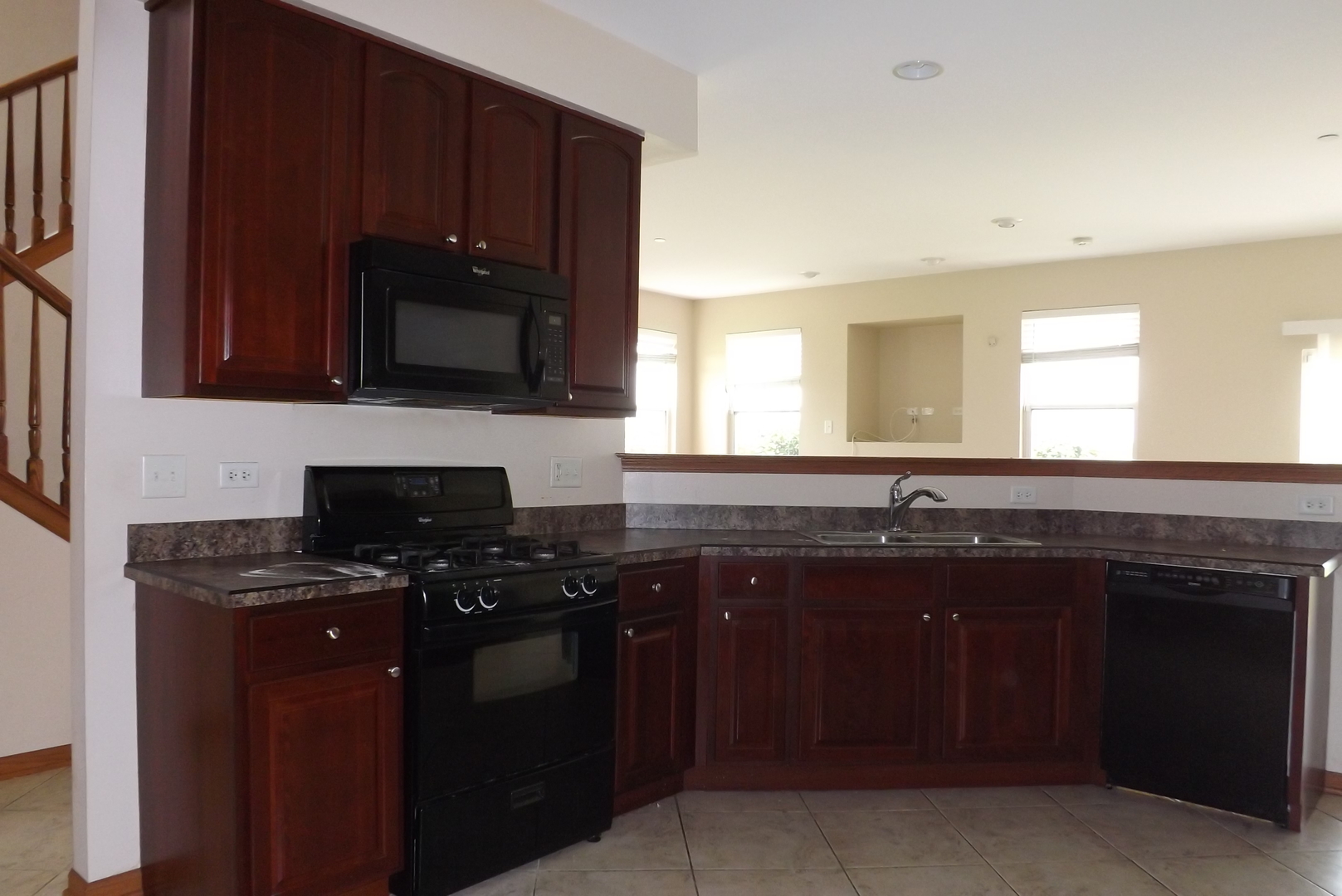 21130 Gray Hawk Drive Matteson, IL 60443 - Photo 7 of 14 a kitchen with kitchen island granite countertop stainless steel appliances a sink a stove cabinets and a window