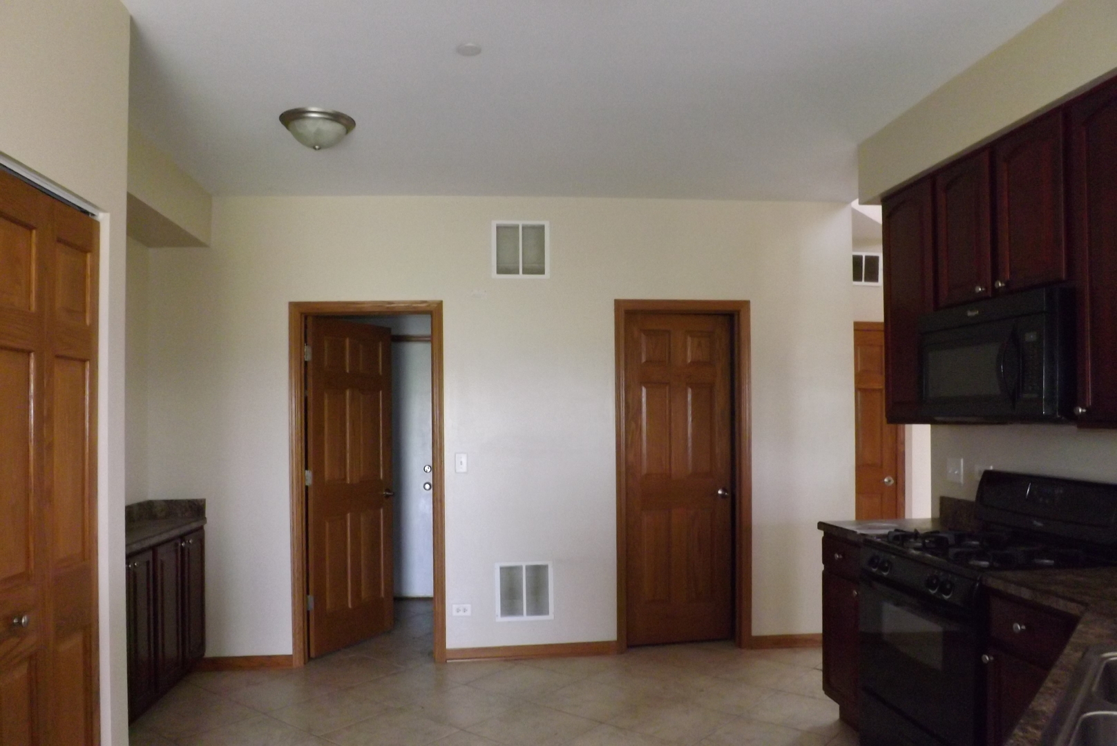 21130 Gray Hawk Drive Matteson, IL 60443 - Photo 9 of 14 a kitchen with a refrigerator and a stove top oven