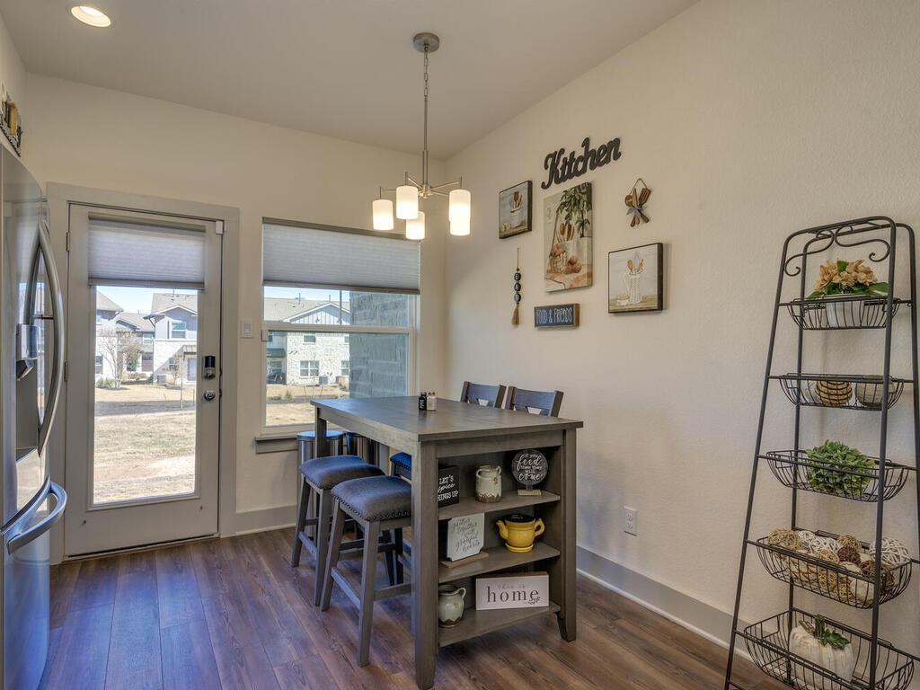 2257 Local Rebel Loop Leander, TX 78641 - Photo 13 of 26 a view of a dining room with furniture window and wooden floor