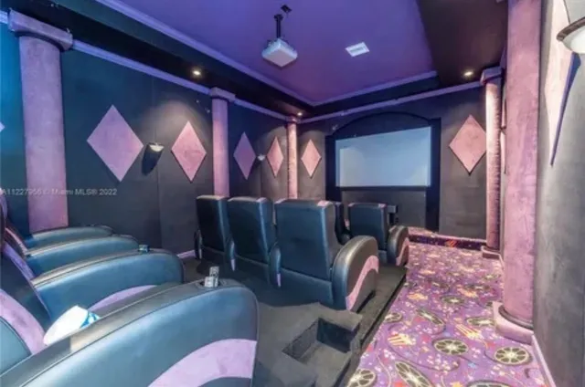 a media room with lots of chairs and a projector