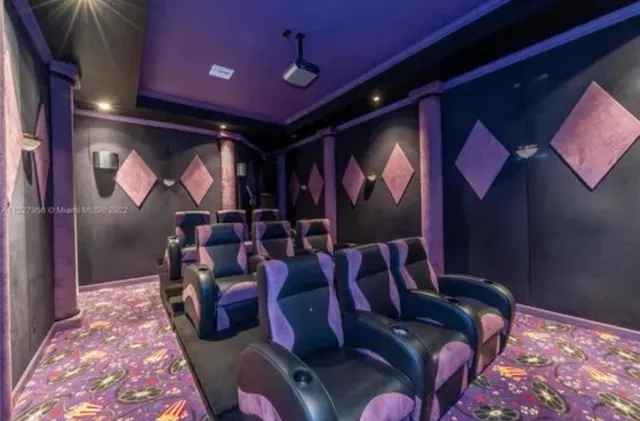 a living room with furniture and a projector screen