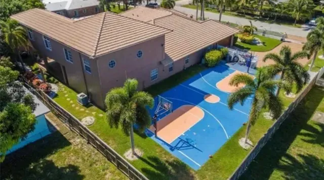 an aerial view of a house with swimming pool and patio