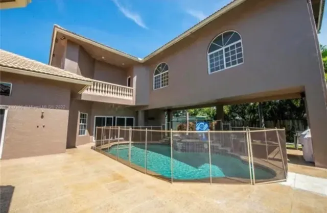 a view of a building with a backyard