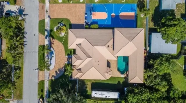 an aerial view of multiple houses with a yard