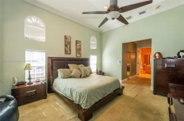 a bedroom with a bed and dresser with mirror