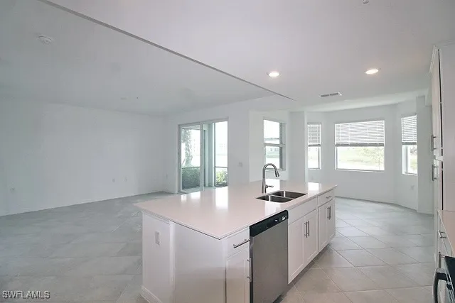 a kitchen with granite countertop a sink and cabinets